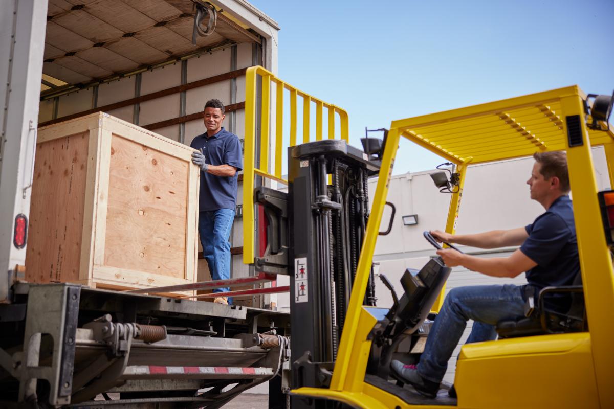Loading crates with a forklift at Navis Pack & Ship. 