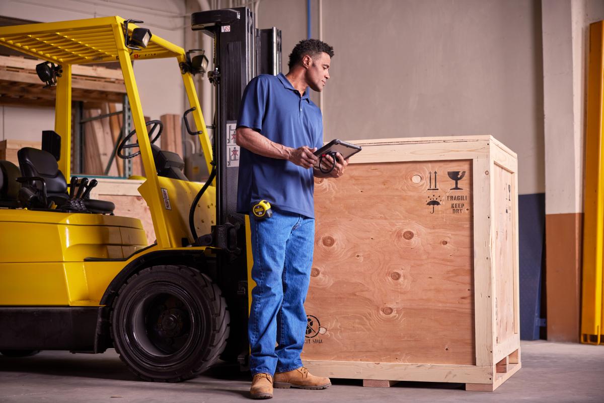 Inspecting a large custom crate before shipment at Navis Pack & Ship